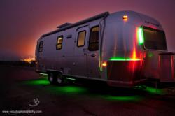 Exterior of Green RV at Night Showing Coloring Changing LED Lights